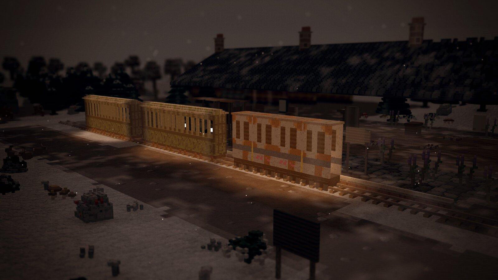 Old carriages stood at the station platform in falling snow, lamplight on the rails and the station roof dark behind